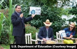 John King, left, reading to students last month.