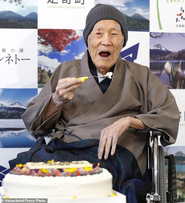 In this April 10, 2018, file photo, Masazo Nonaka eats a cake after receiving the certificate from Guinness World Records as the world