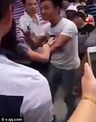 This is the shocking moment a Chinese man beat his wife and her alleged lover in a market