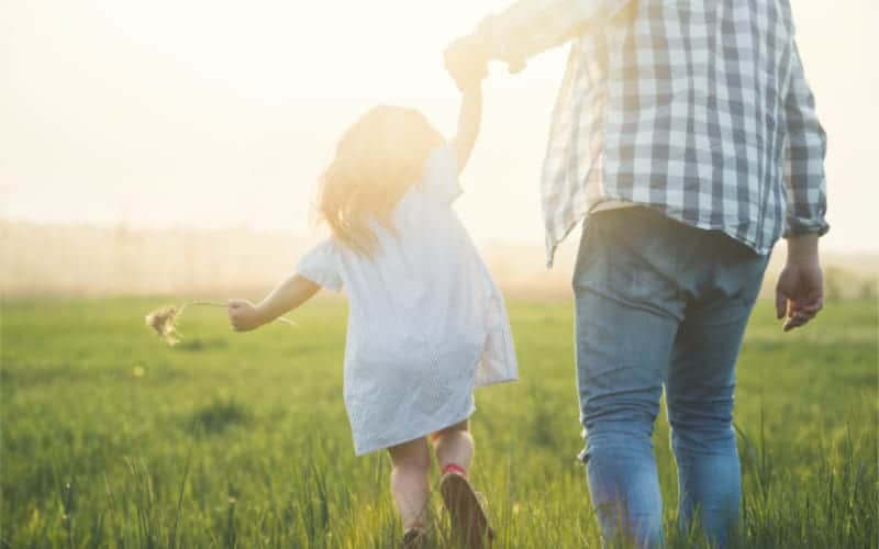 dad playing with his daughter outside