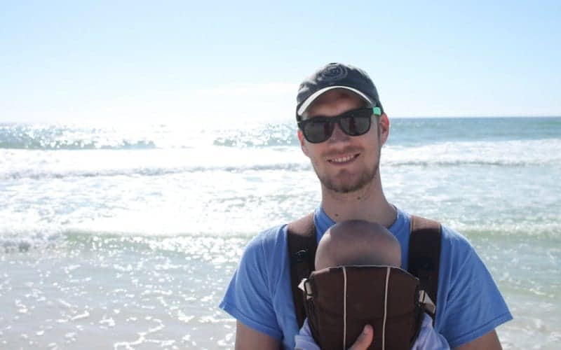 dad with his baby at the beach