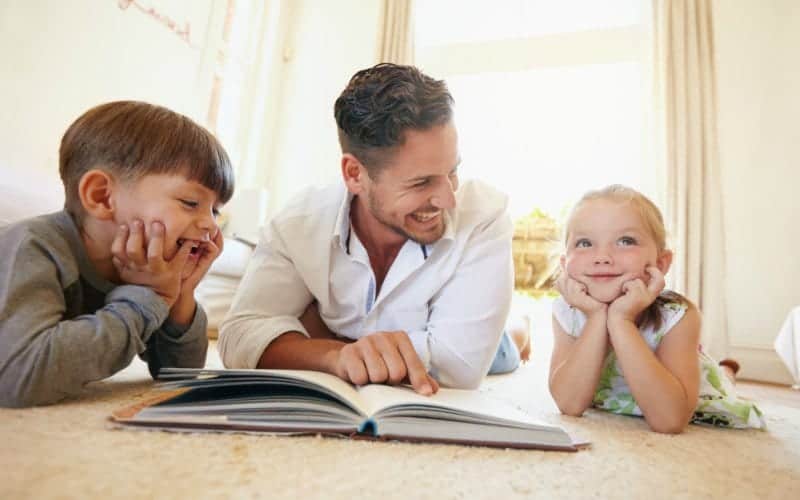 dad reading with his two kids