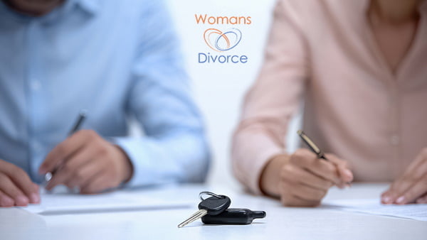 Couple signing a divorce settlement agreement dividing their debts and assets